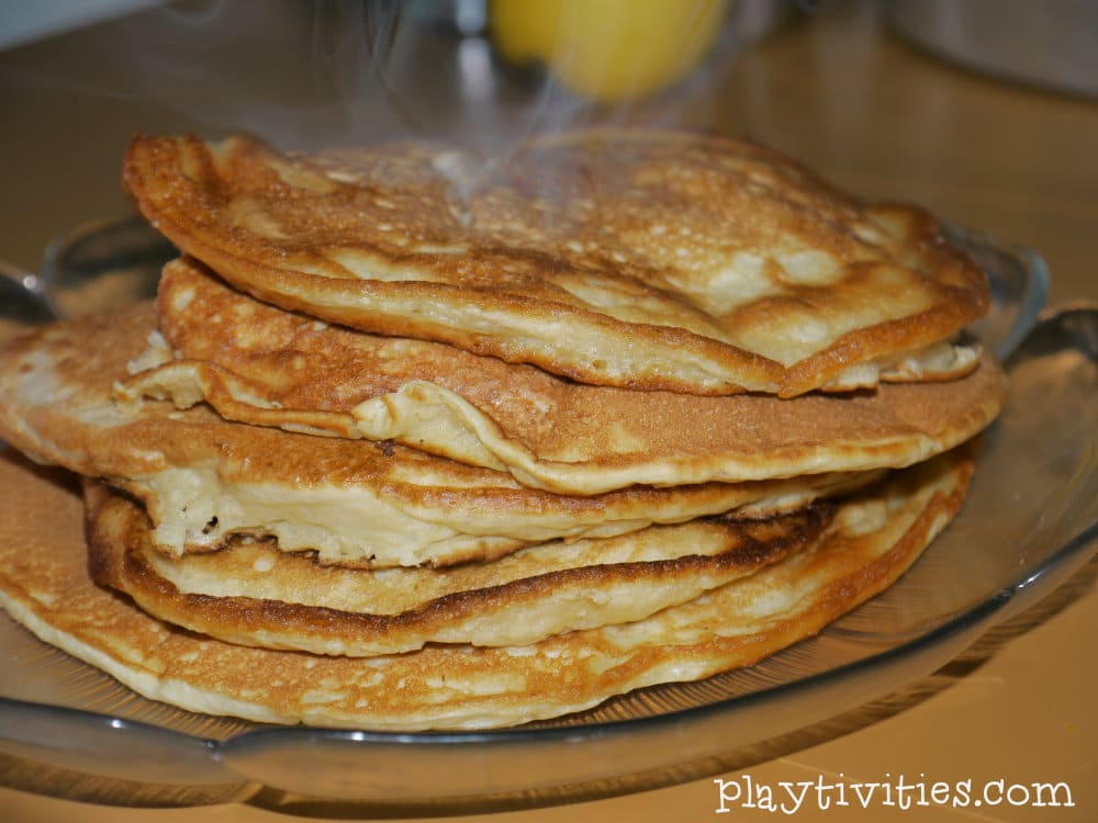 Pile of pancakes on a tray.