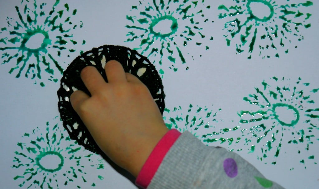 Toddler stamping with crotchet coaster.