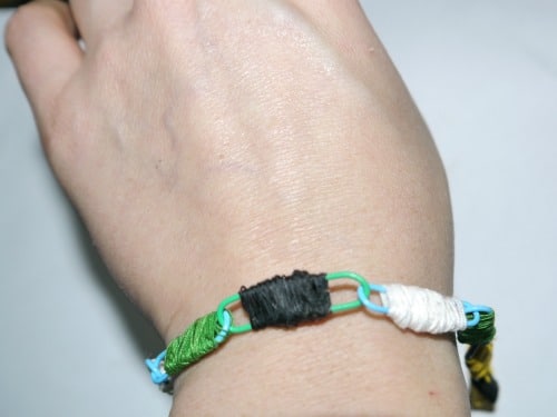 Paper clip bracelet on a hand.