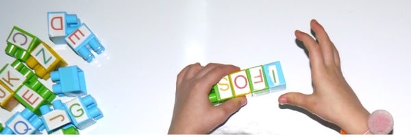 Kid playing with spelling lego blocks