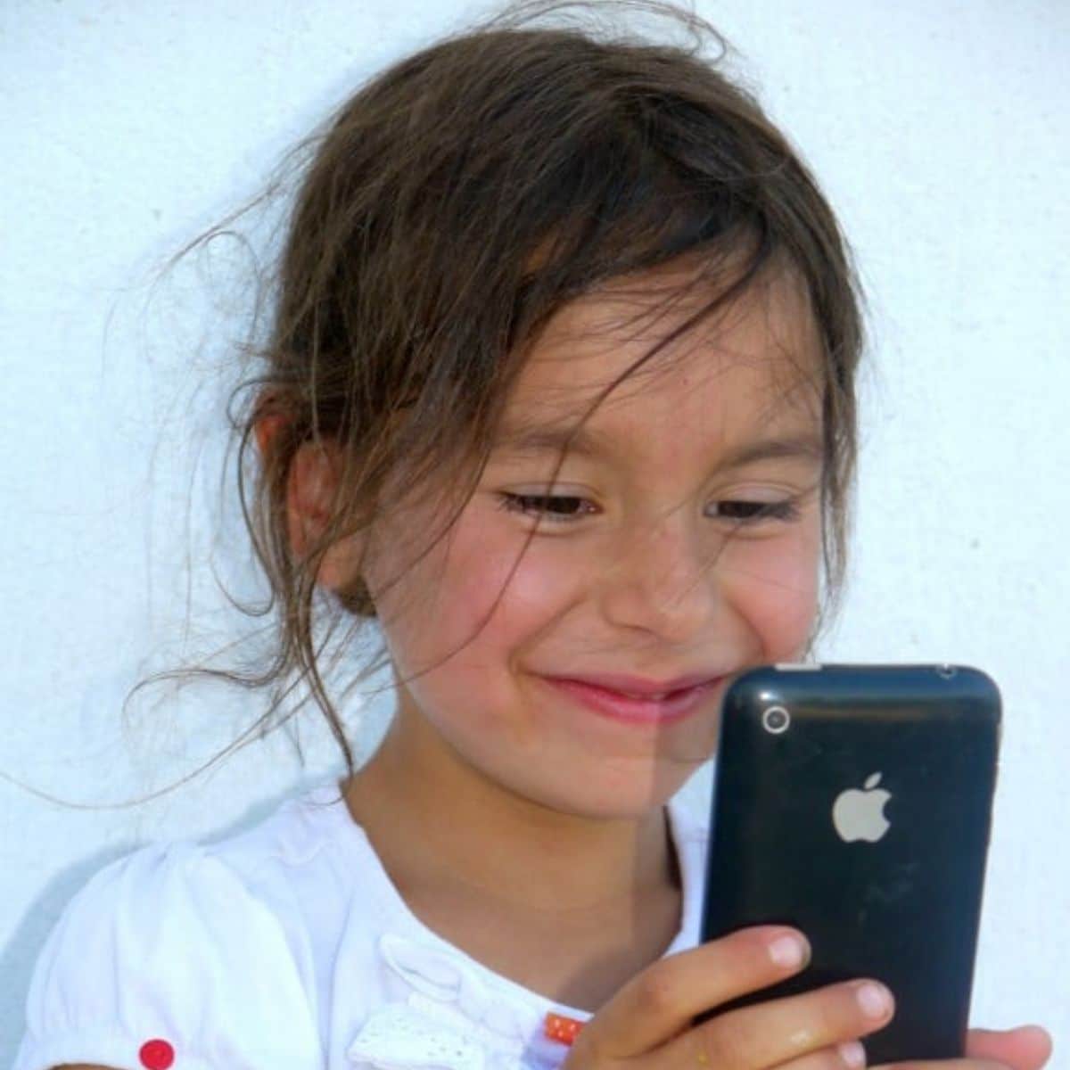 Young girl holding an Iphone