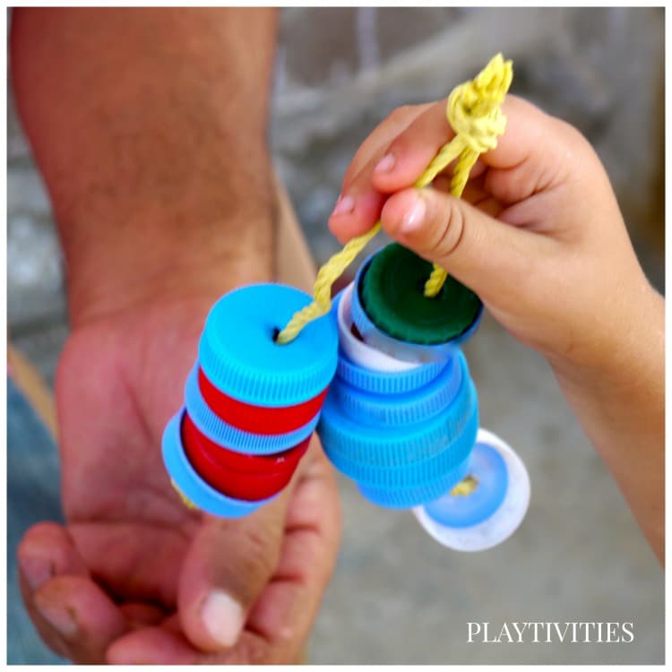 Kid hand holding a Recycled DIY Toy For Baby