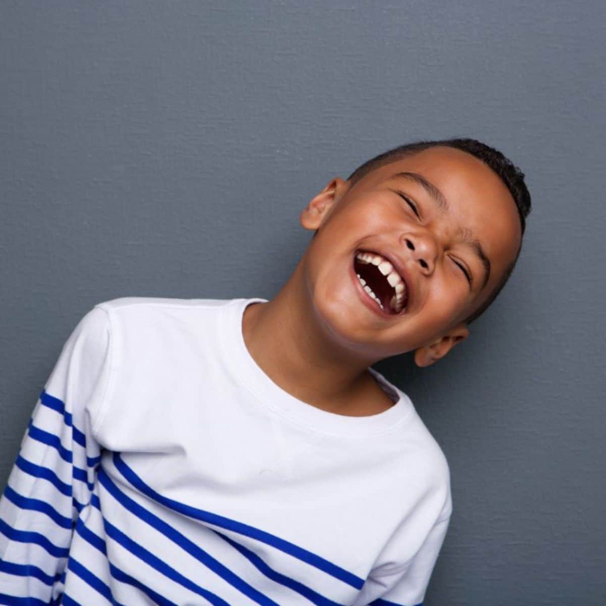 Young black kid laughing.