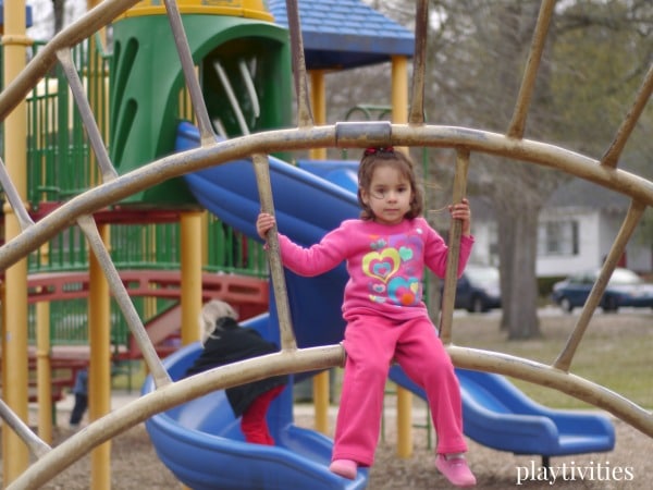 Young girl playing on a playground.