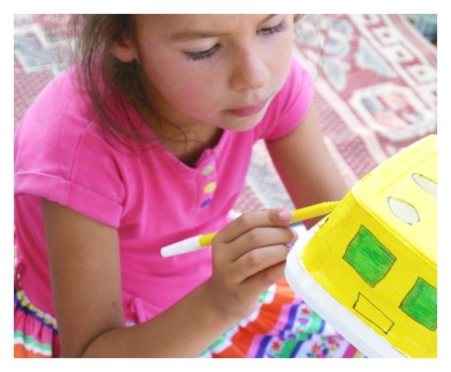 Girl corloing a DIY Pencil Holder That Looks Like School Bus