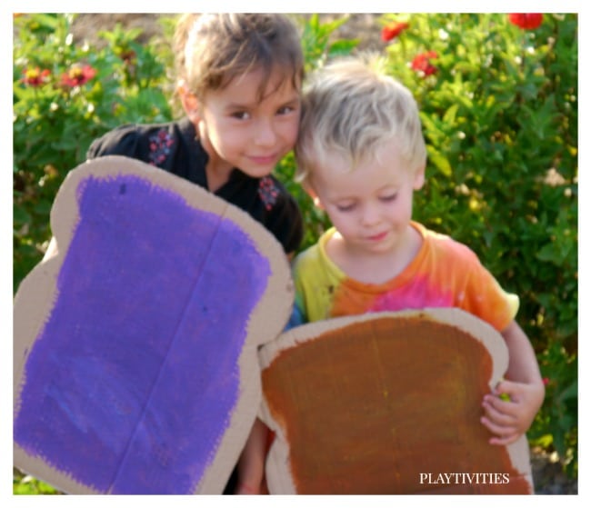 Sibling wearing a peanut butter and jelly cardbaord costumes.