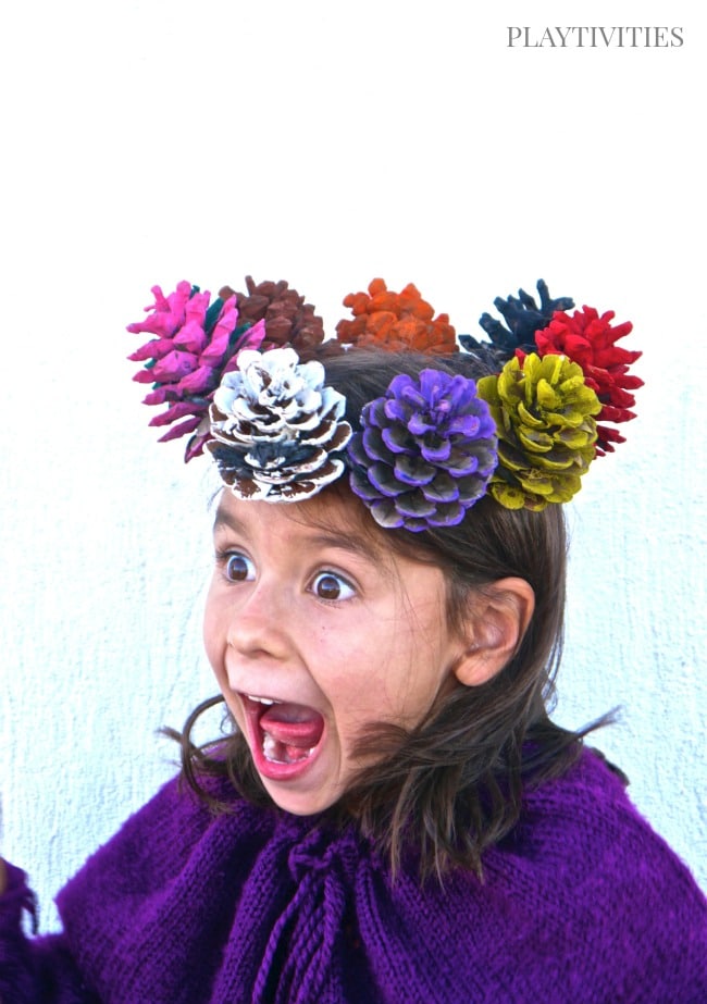 Young girl wearing a pinecone crown.