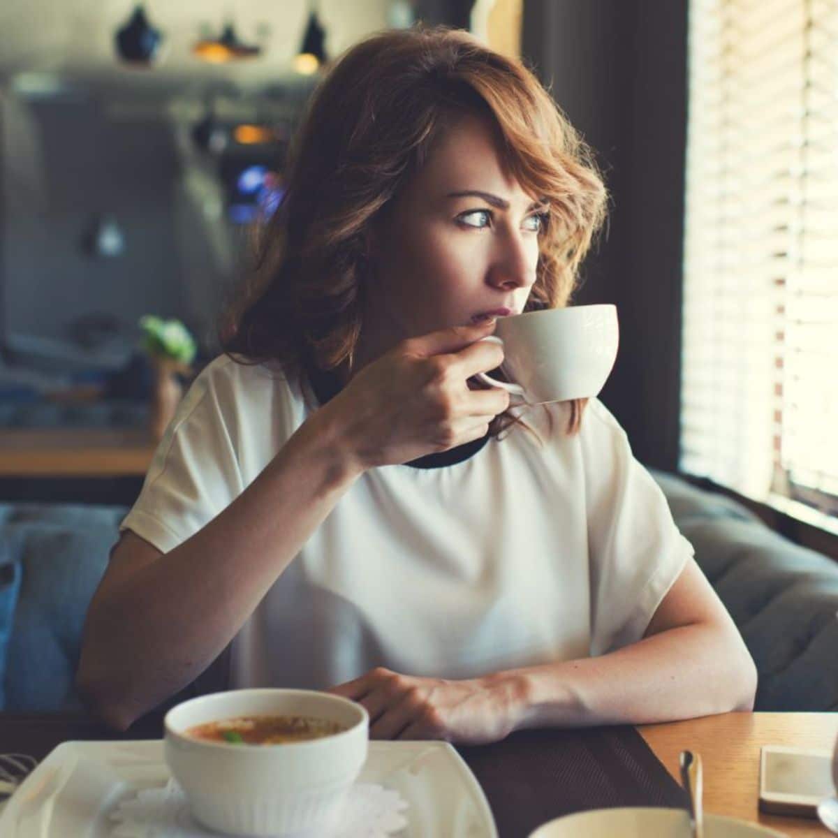 Young woman sipping a coffe.