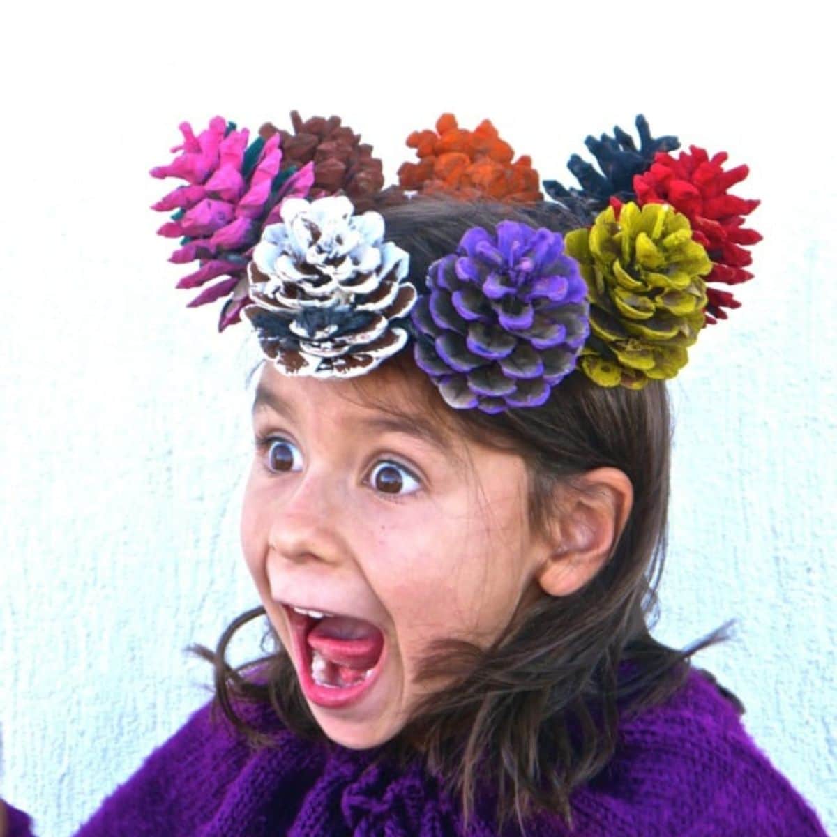 Young girl wearing a pinecone crown.