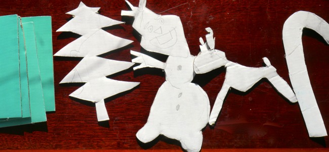 Cartoon characters made from cardboards on a table.