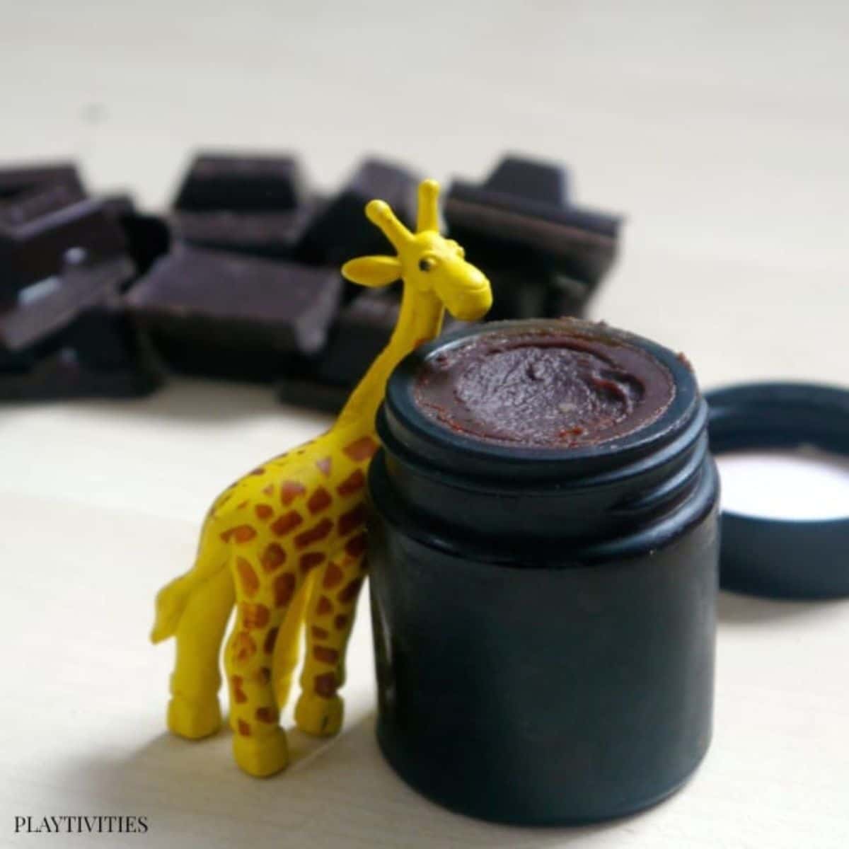 homemade lip balm with a giraffe toy.
