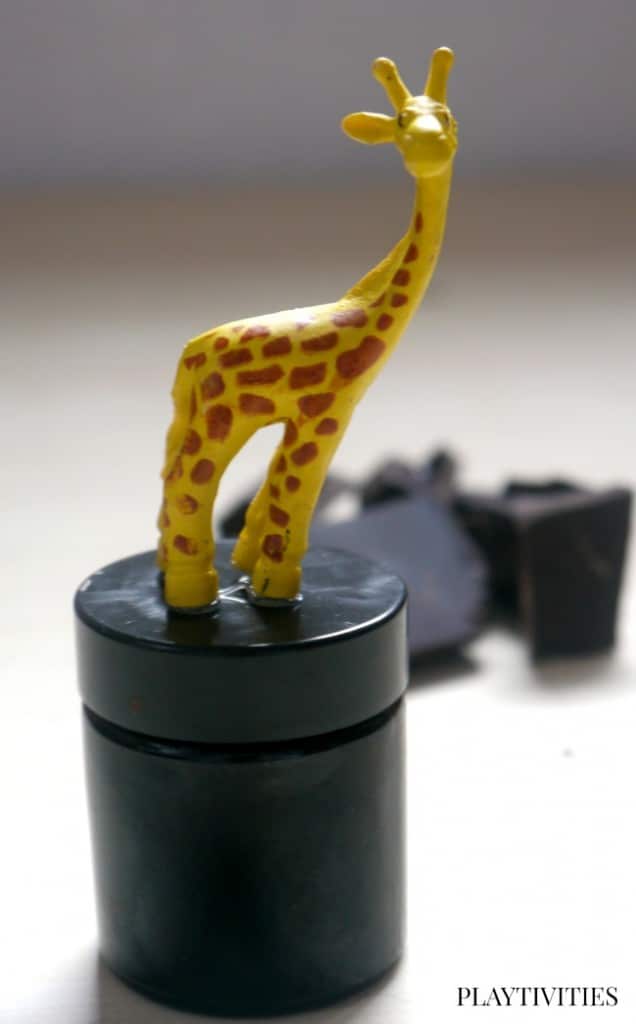 Delicious Homemade Lip Balm with a giraffe toy.