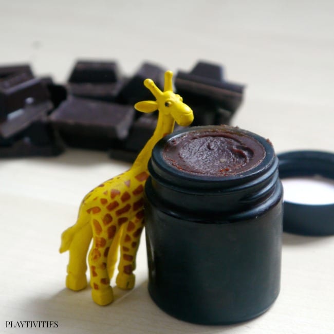 Delicious Homemade Lip Balm with a giraffe toy.