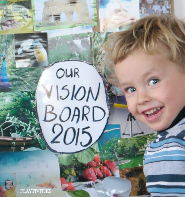 Smiling young boy infront of vision board.