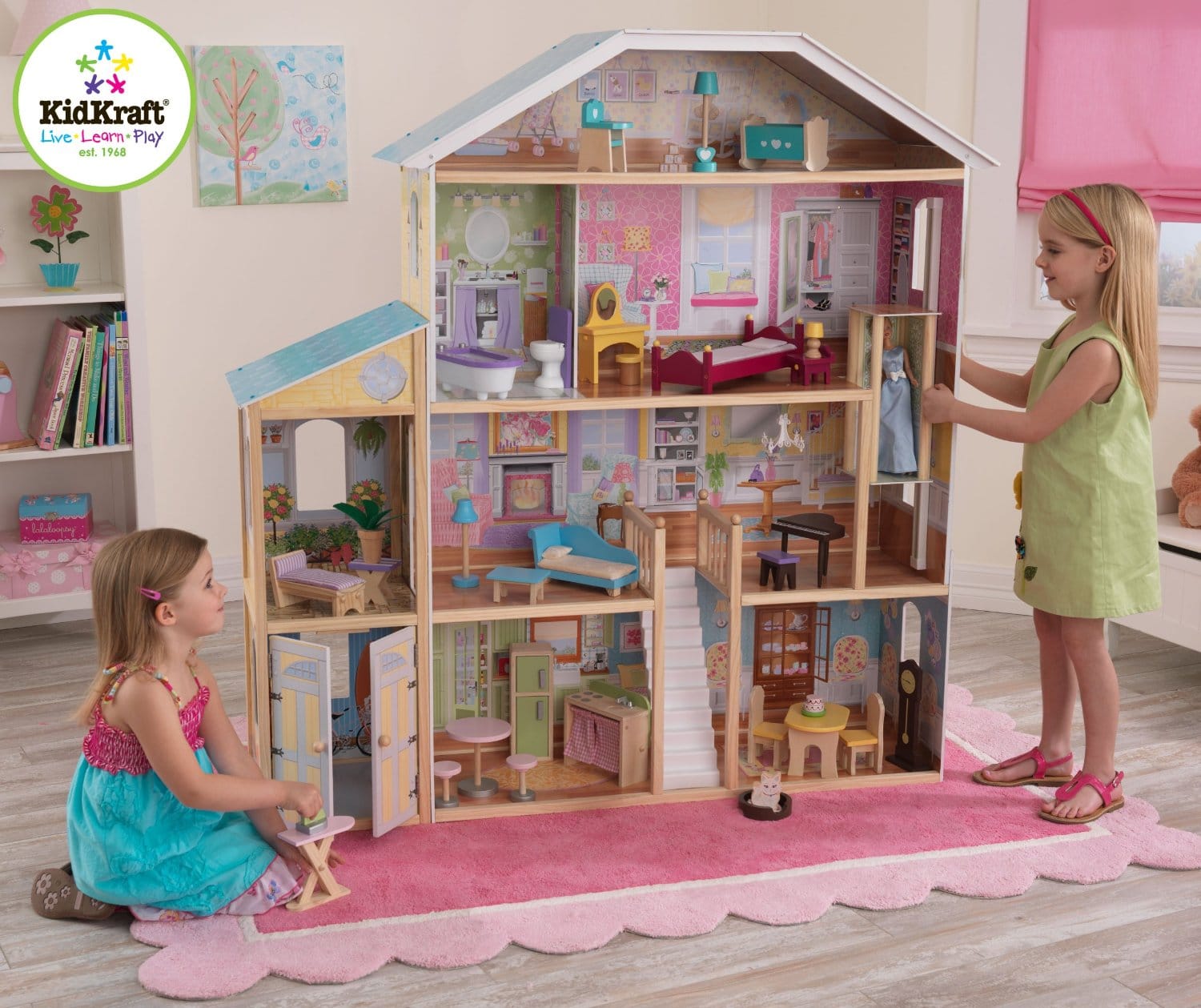 Two kids playing with big dollhouse.