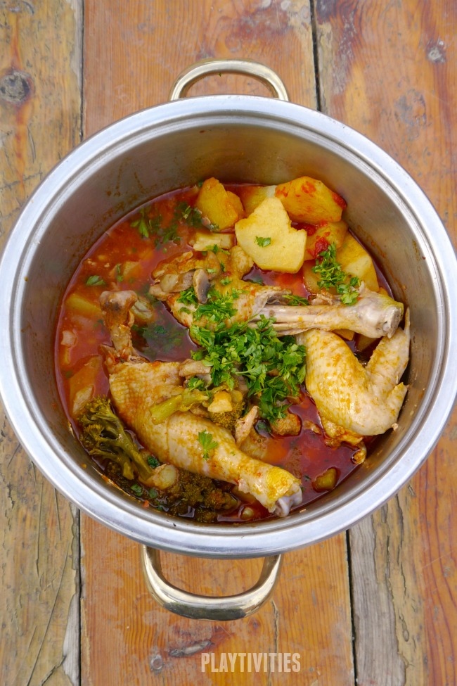 One pot chicken in a pot on a wooden table.