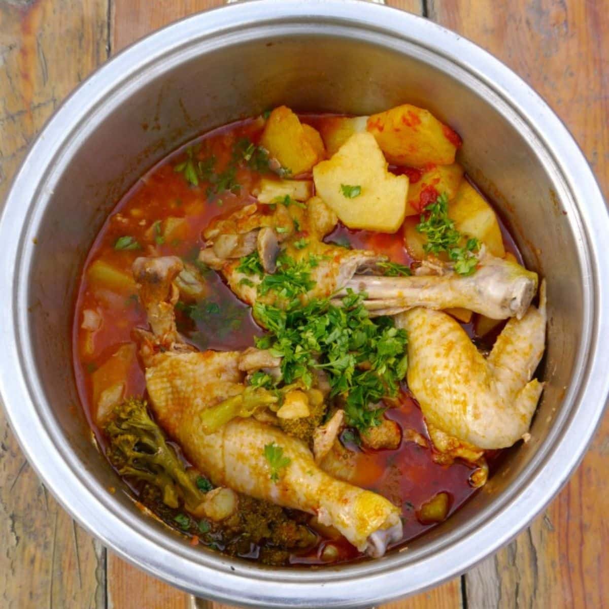 Chicken with vegetables in a pot on a table.