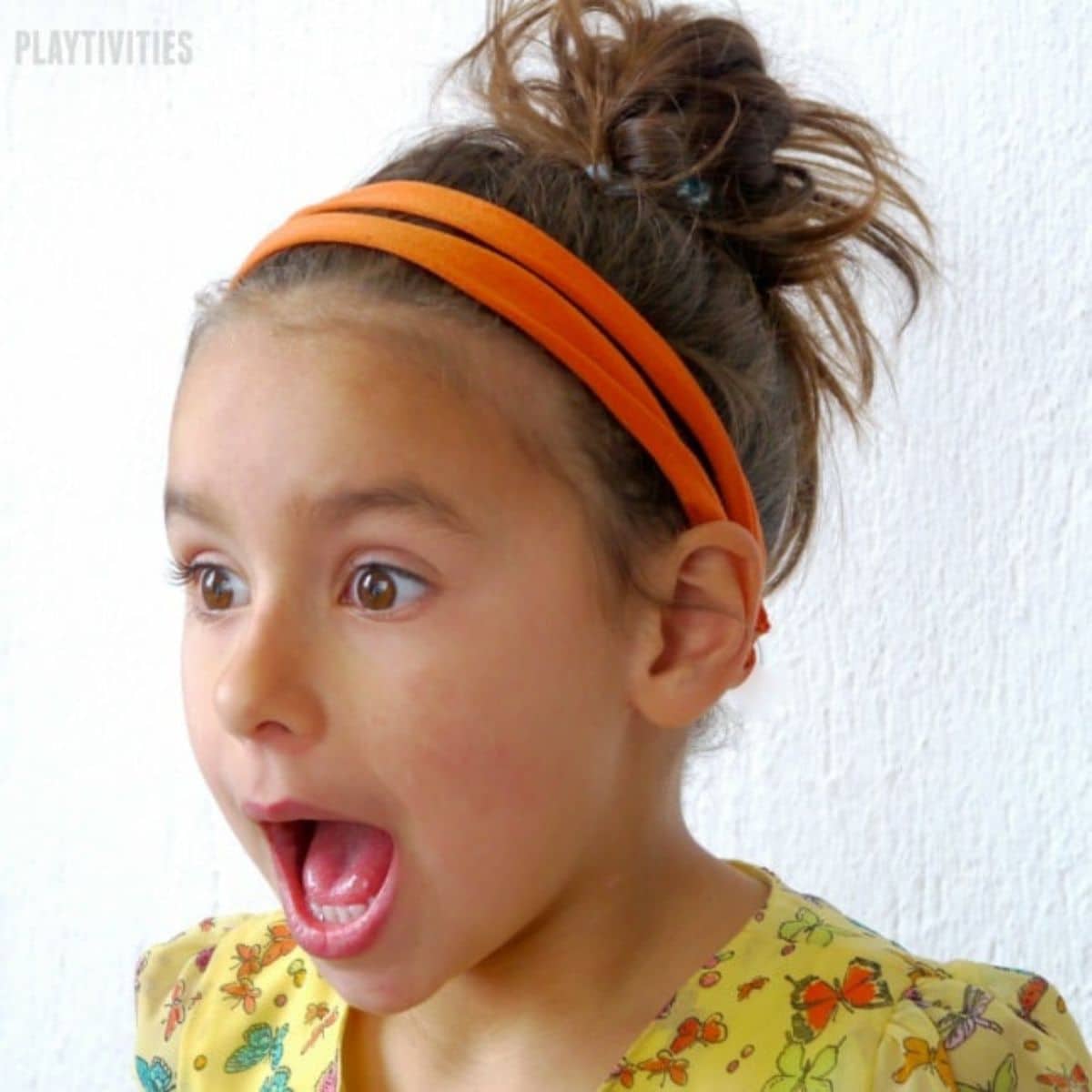 Young girl wearing an orange diy headband,