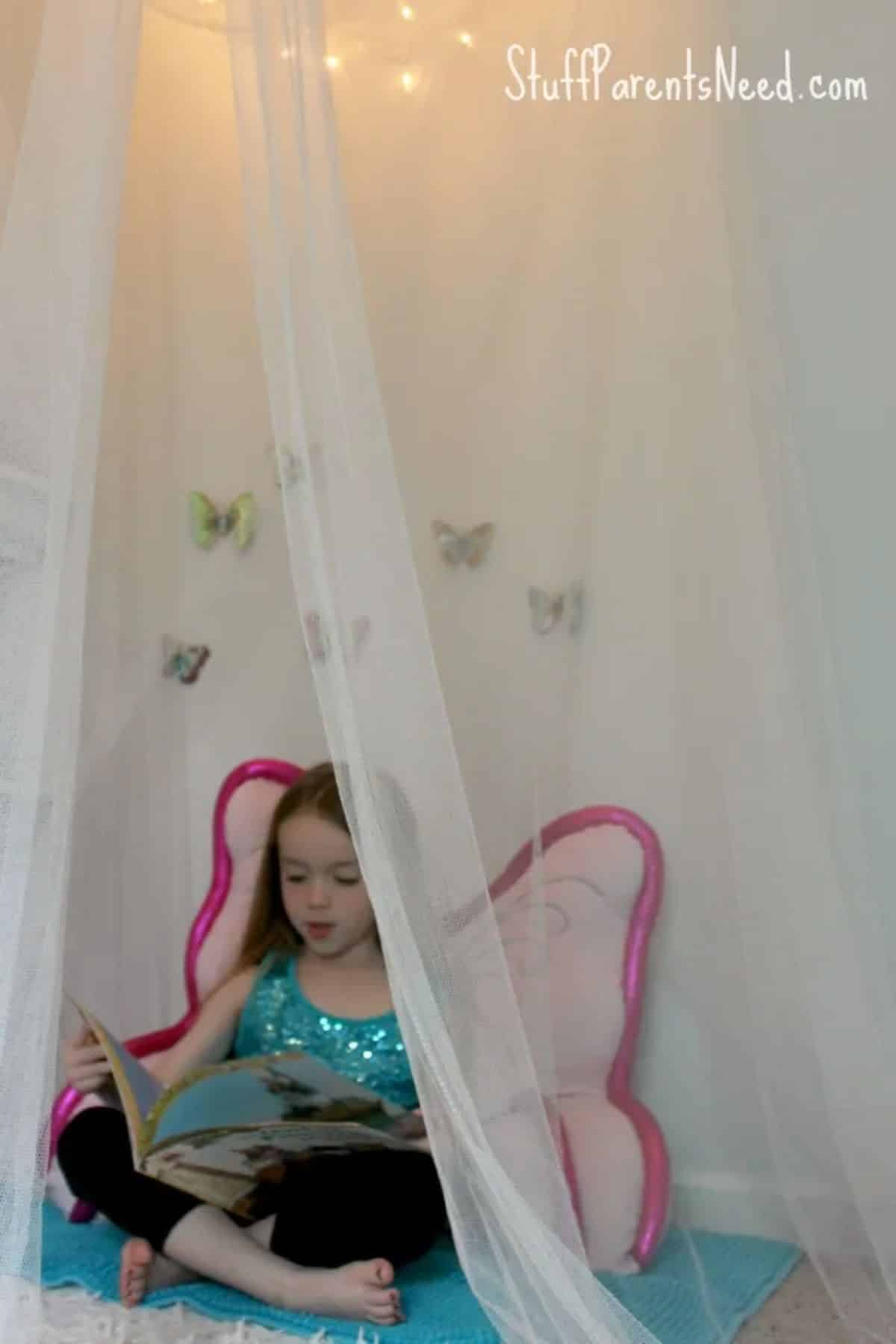 DIY reading nook with a kid inside.