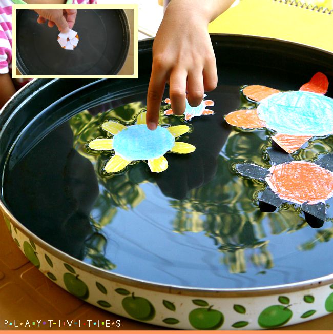 Paper lillies in a water bowl.