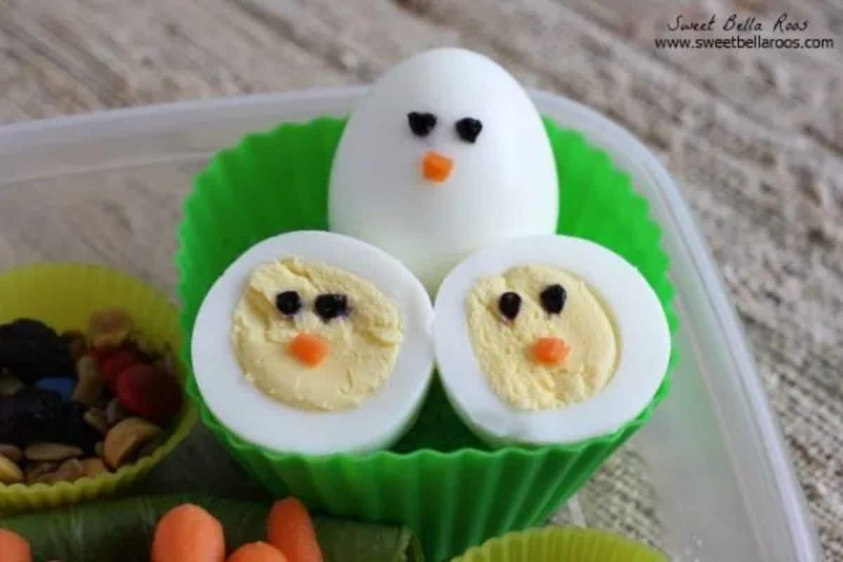 Hard boiled eggs in a green plastic box.