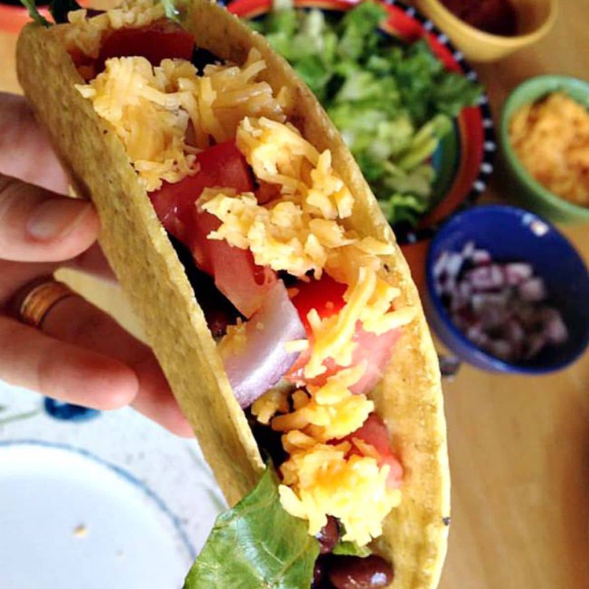 Hand holding an easy made taco for kids.
