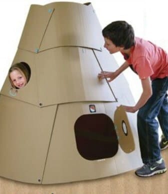 Two kdis playing in cardboard space pod.