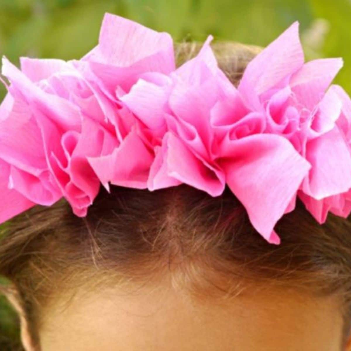 Pink paper tissue headban on a head.