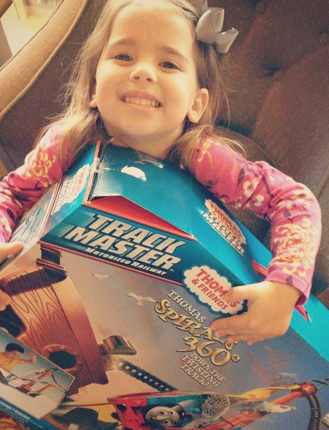 Young girl holding a track master package.