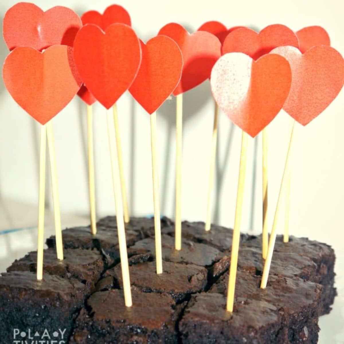 Bunch of brownies with heart sticks.
