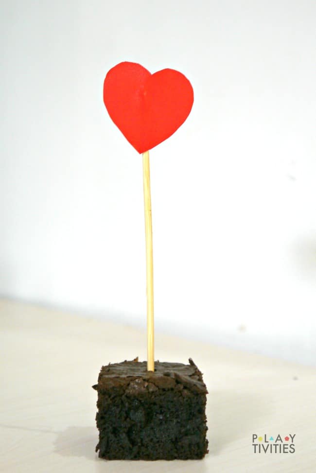 Valentines day brownie with paper heart on stick.