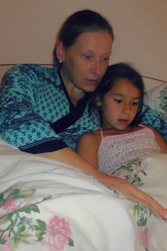 Mother and daughter lying in a bed.