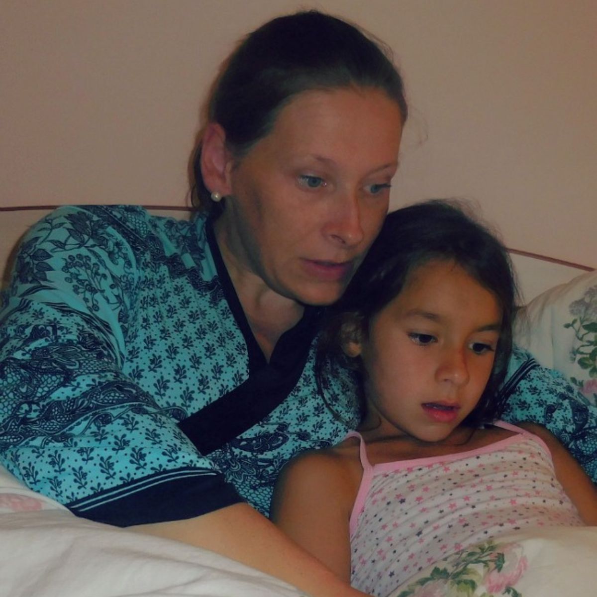 Mother and daughter lying in a bed