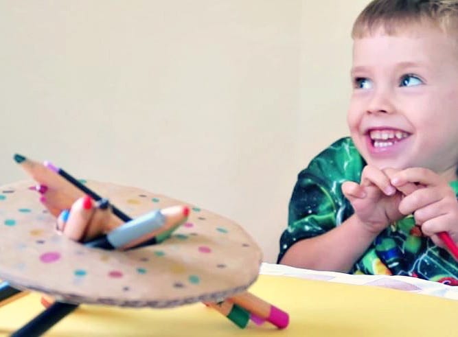 Young boy smiling and playing a donut family game.