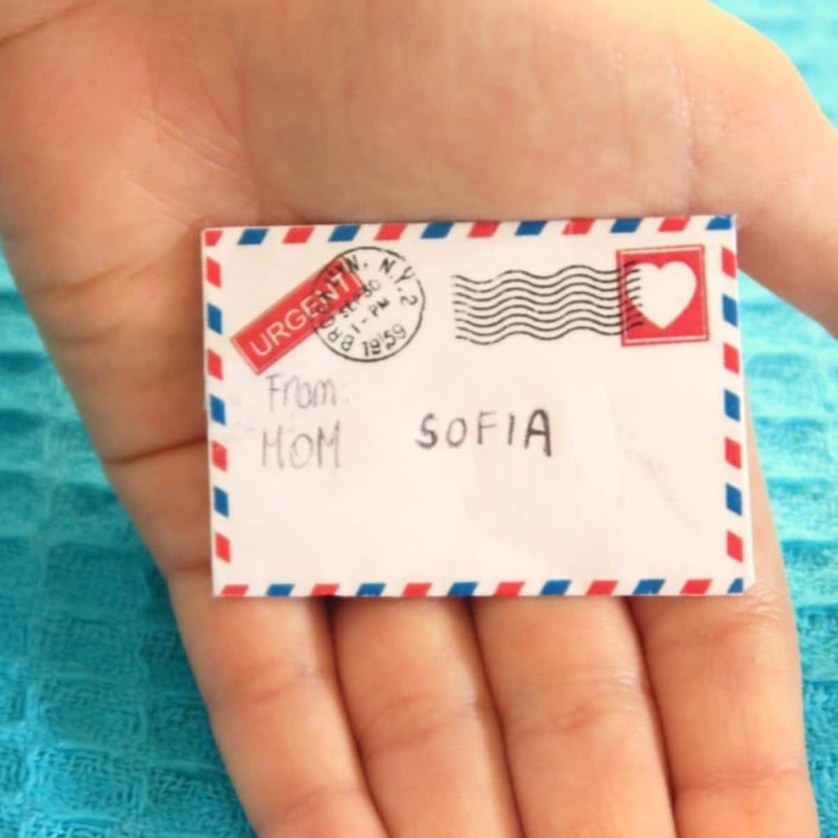 Mini love letter on a palm of hand.