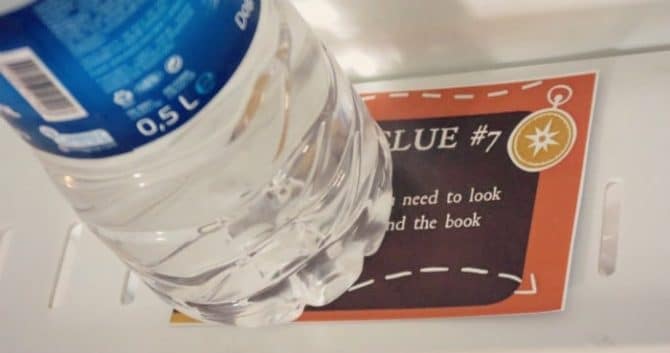 Treasure hunt clue card under a bottle of water.