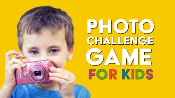 Boy holding a camera nexto to sign Photo challenge game for kids.