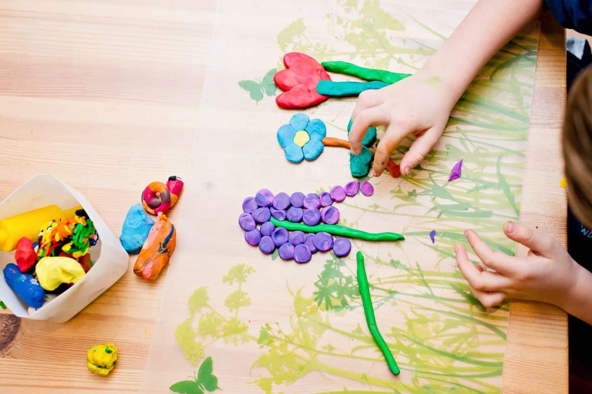 Children playing with a playdough and making a forest art.