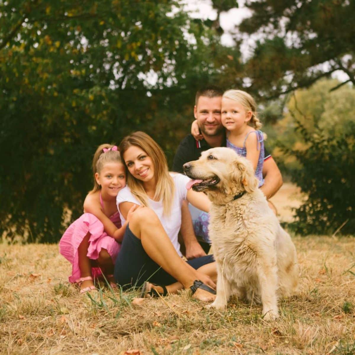 Young family with a dog in nature.