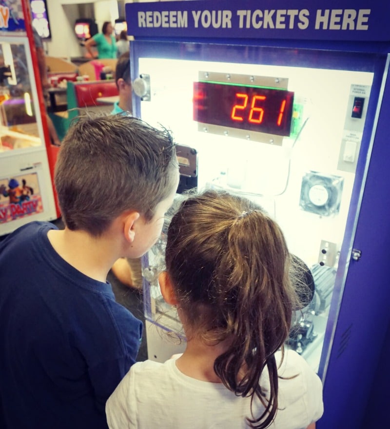 Two kids buying tickets at ticket's automat.