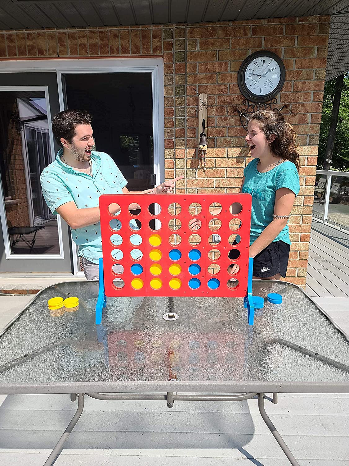 Father and daughter playing a backyard funny game.