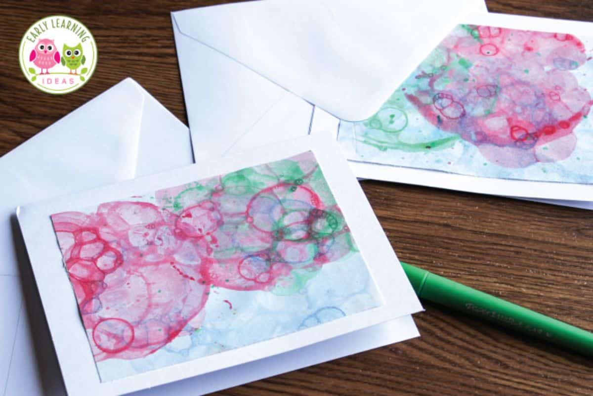 Two paper sheets with bubble painting on the table.