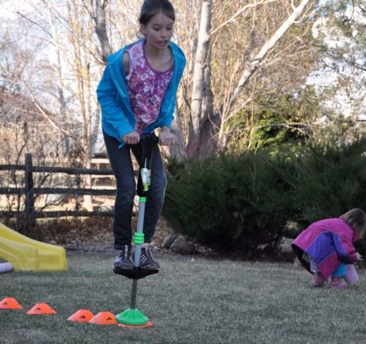 Two girls  playing in activity obstacle course outdoor.
