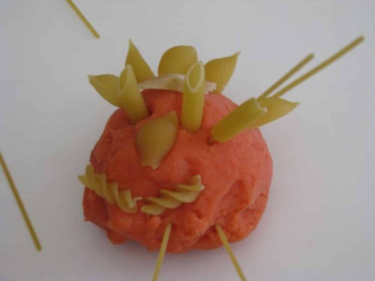 Playdough monster with a pasta.