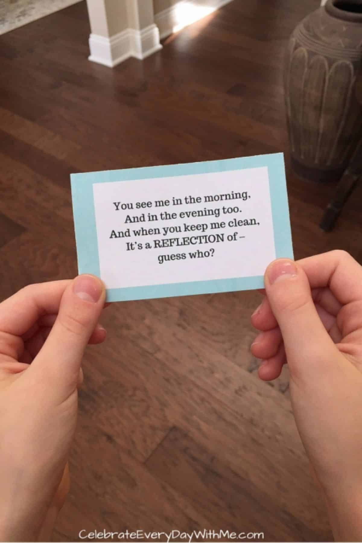Hands are holding a scavenger hunt card with instructions.
