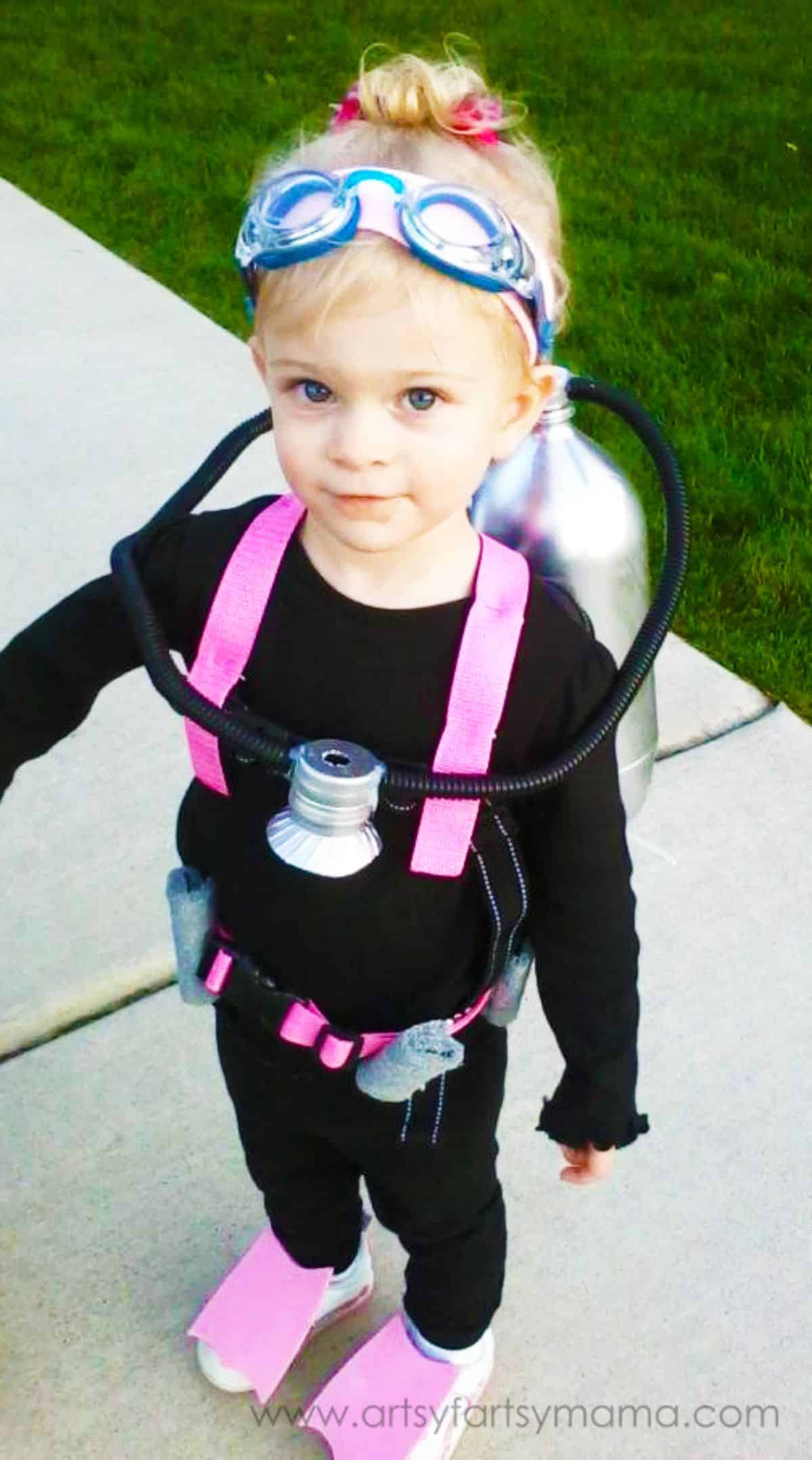 Blonde girl is wearing a scuba diver halloween csotume.