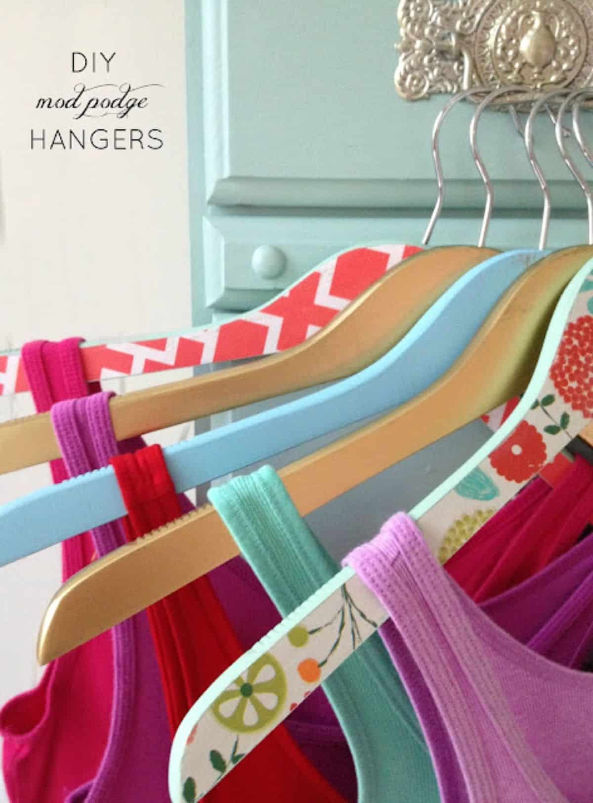 Colorful wooden coat hangers with shirts on.