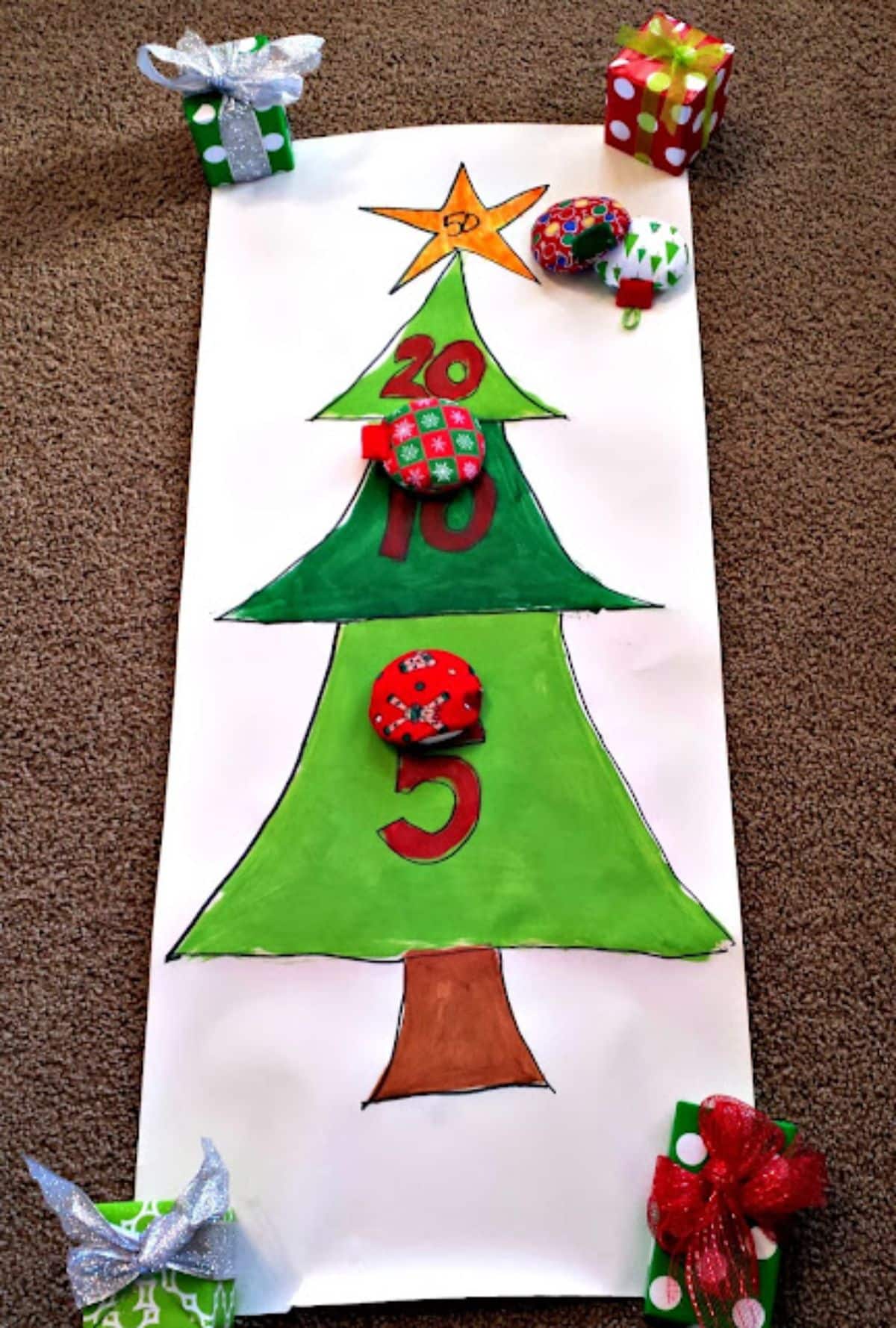 Paper sheet with a drawn chritmas game on a carpet with small christmas gifts.