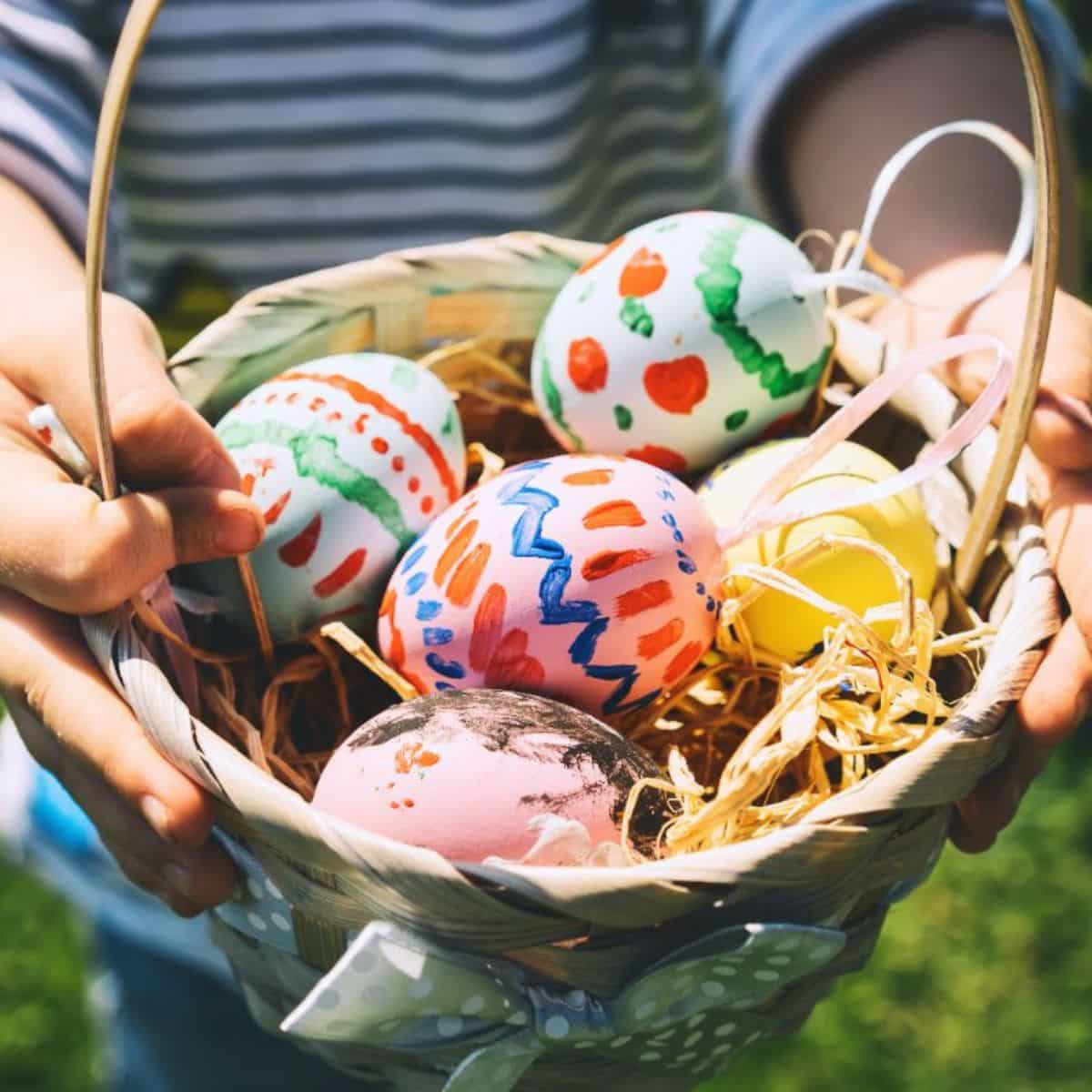 Children holding a basket full of easter eggs.