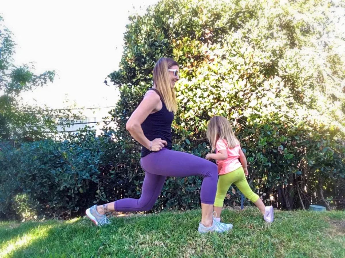 Mom and daughter working out together outdoor.